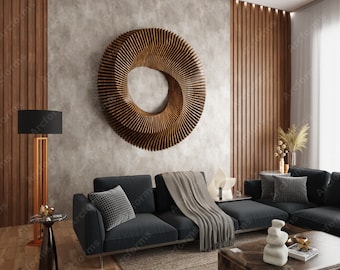 May include: A modern living room with a dark gray sectional sofa, a wooden coffee table, and a large wooden wall sculpture. The room has a light gray wall with a wooden accent wall and a large window with white curtains.