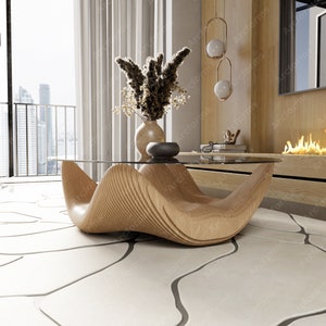 Puede incluir: Una mesa de centro moderna de madera con un diseño único en forma de onda. La mesa tiene una tapa de vidrio y está sobre una alfombra blanca con un diseño estampado.