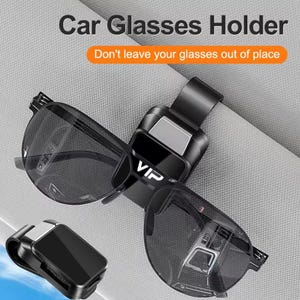 May include: A black car glasses holder with a silver accent, holding sunglasses. The holder is attached to a car's interior. The text "VIP" is visible on the holder. The text "Car Glasses Holder" and "Don't leave your glasses out of place" are also visible.