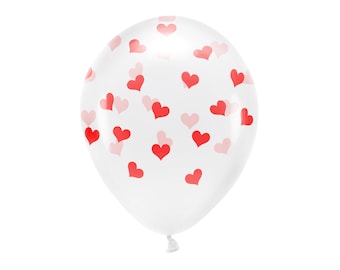 Puede incluir: Un globo blanco con un patrón de corazones rojos y rosas.