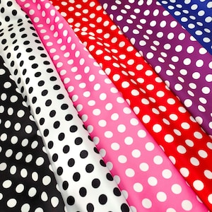 May include: Five different fabric swatches with white polka dots on a black, white, pink, red, and purple background.