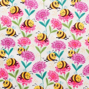 May include: A repeating pattern featuring cartoon bees and pink flowers on a white backdrop. The bees are yellow and brown with smiling faces. The flowers are a vibrant pink with green stems and leaves.