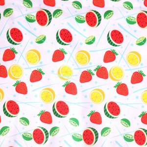 May include: A pink background with a repeating pattern of watermelon slices, lemons, limes, and strawberries. The pattern is on a white background with blue lines and white stars.