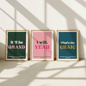 May include: Three framed art prints with motivational phrases. The prints display the phrases "It'll be GRAND", "I will, YEAH", and "What's the CRAIC" in bold fonts against colored backgrounds. The frames are a light wood color.
