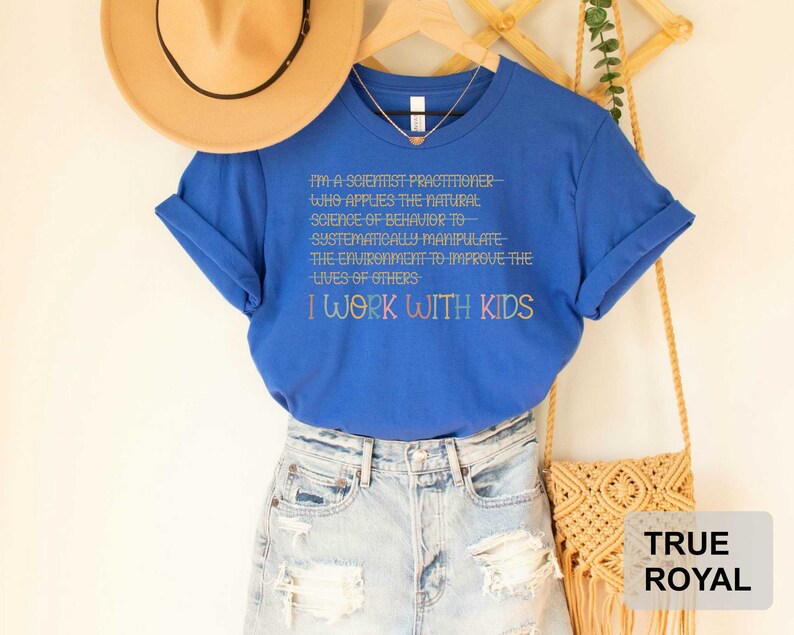 May include: A royal blue t-shirt with the text "I'm a scientist practitioner- who applies the natural science of behavior to systematically manipulate the environment to improve the lives of others I work with kids".