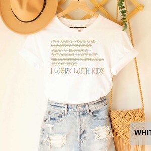 May include: White t-shirt with a graphic that says "I'm a scientist practitioner who applies the natural science of behavior to systematically manipulate the environment to improve the lives of others. I work with kids."