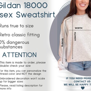 May include: A light gray Gildan 18000 unisex sweatshirt with a crew neck. The image includes text detailing product features, sizing instructions, and a diagram showing width, length, and sleeve measurements for this specific garment style.
