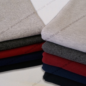 May include: A stack of different coloured fabric swatches. The swatches are folded and stacked on top of each other. The colours of the swatches are grey, dark grey, red, navy blue, and black. The text "CO.UK RICHER-FABRICS.CO.UK RICH" is printed on the fabric swatches.