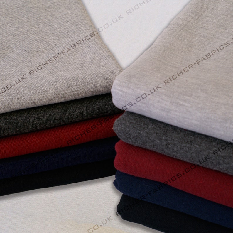 May include: A stack of different coloured fabric swatches. The swatches are folded and stacked on top of each other. The colours of the swatches are grey, dark grey, red, navy blue, and black. The text "CO.UK RICHER-FABRICS.CO.UK RICH" is printed on the fabric swatches.