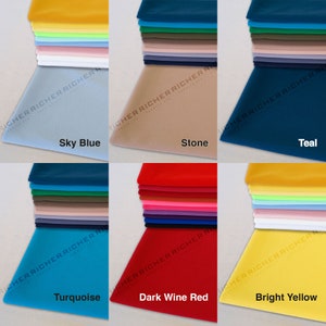 May include: A collection of 10 fabric swatches in various colors, including sky blue, turquoise, stone, teal, dark wine red, and bright yellow. The swatches are stacked on top of each other and are arranged in a grid pattern.