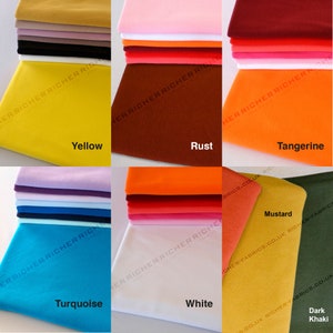 May include: A collection of 10 different coloured fabric swatches. The colours are yellow, rust, tangerine, mustard, turquoise, white, dark khaki, purple, light blue, and black.