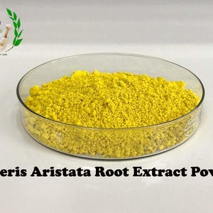 May include: A close-up of a yellow powder, Berberis Aristata Root Extract Powder, in a clear glass dish.
