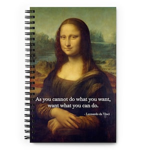 Könnte beinhalten: Ein spiralgebundenes Notizbuch mit einer Reproduktion von Leonardo da Vincis Mona Lisa auf dem Cover. Unter dem Bild ist das Zitat "Da du nicht tun kannst, was du willst, will das, was du tun kannst." gedruckt, zugeschrieben Leonardo da Vinci.