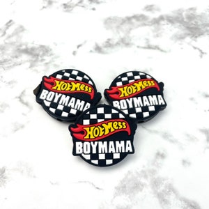 May include: Three black and white checkered circle shoe charms with a red and yellow Hot Mess Boymama logo.