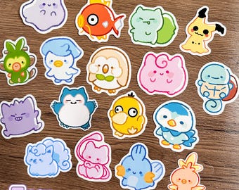 May include: A collection of fifteen die-cut vinyl stickers featuring colorful cartoon creatures in a hand-drawn style. Each sticker measures 7 cm. The characters include various shapes and colors like orange, blue, pink, green, and yellow.