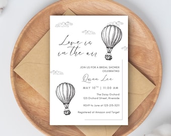May include: A bridal shower invitation with a hot air balloon illustration. The invitation reads "Love is in the air" and includes details for the event, such as the date, time, location, and RSVP information.