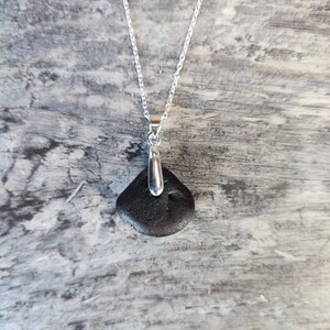 Amazing amber sea glass pendant on 22cm long silver plated chain.