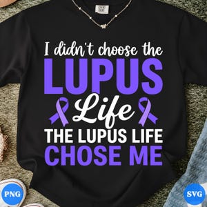 May include: Black t-shirt with the text "I didn't choose the LUPUS Life, THE LUPUS LIFE CHOSE ME" in white and purple. The design includes a purple awareness ribbon. The shirt is made of a soft material.