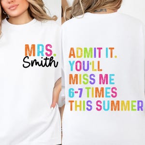 May include: White t-shirt with the text "MRS. Smith" in orange and black on the front. The back of the shirt has the text "ADMIT IT. YOU'LL MISS ME 6-7 TIMES THIS SUMMER" in various colors. The shirt is a casual, unisex style.