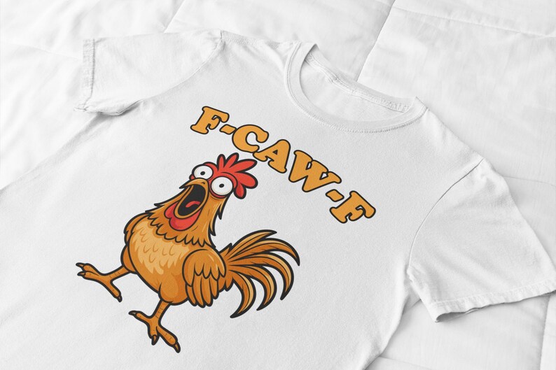 May include: White t-shirt featuring a cartoon chicken with an open beak and the text "F-CAW-F" in orange. The chicken is brown, with a red comb and tail feathers.