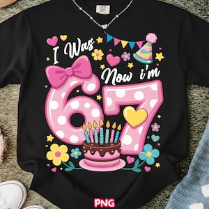 May include: Black t-shirt with a colorful birthday design. The graphic includes the text "I Was 6 Now I'm 7" with a large pink number 6 and 7, a birthday cake, and decorative elements like flowers and hearts.