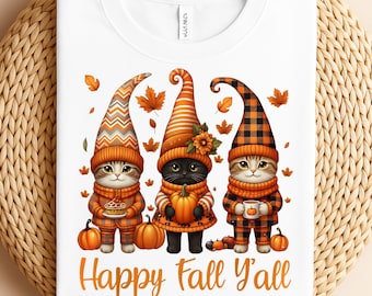 May include: White sweatshirt featuring a fall-themed graphic with three cartoon cats dressed as gnomes. The cats wear orange and brown outfits, holding pumpkins and mugs. The text "Happy Fall Y'all" is below the image.