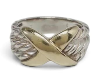 May include: A two-tone ring featuring a polished gold-colored X-shaped centerpiece overlaid on a silver-colored band with a twisted rope-like texture. The band has a wide, rounded profile with a smooth interior surface and a metallic finish.