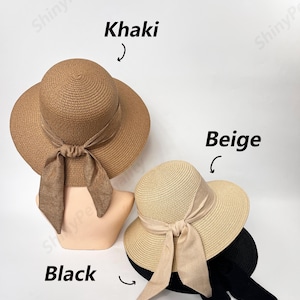 May include: Three straw sun hats with ribbon ties. The hats are in khaki, beige, and black.