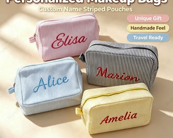 May include: Four rectangular zippered makeup pouches with vertical stripes in pink, light blue, black, and yellow. Each pouch features a name embroidered in cursive script: Elisa, Alice, Marion, and Amelia. The text Personalized Makeup Bags and Custom Name Striped Pouches is visible at the top.