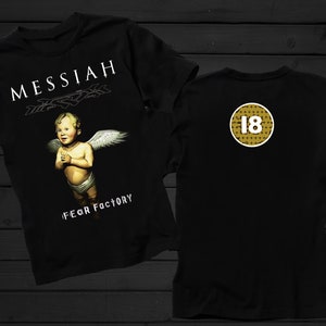 May include: Black t-shirt with a graphic of a winged baby angel with the text "MESSIAH" and "FEAR FACTORY" printed on the front. The back of the shirt has a gold circle with the number "18" printed inside.