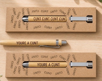 May include: Two bamboo pens with silver accents and the phrases "CUNT CUNT CUNT CUNT" and "YOURE A CUNT" printed on them. The pens are packaged in cardboard boxes with the word "CUNT" printed repeatedly.