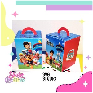 May include: Two blue and red cardboard boxes with a handle on top. The boxes feature a Paw Patrol theme with images of the characters, including Chase, Marshall, Skye, and Rubble. The text on the box says "Gracias por venir".