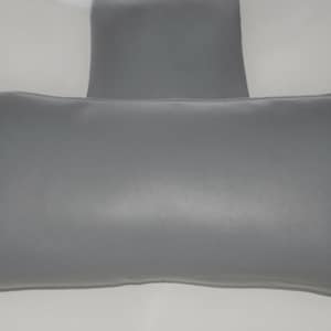 May include: A grey rectangular pillow with a smaller grey rectangular pillow attached to the top centre.