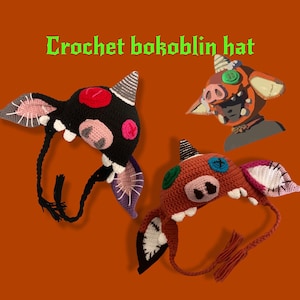 May include: Handmade crochet Bokoblin hats in black and brown, with distinctive ears, horns, and facial features. These hats have a unique, cartoon-like design, ideal for cosplay or themed occasions. The text "Crochet bokoblin hat" is displayed in green.