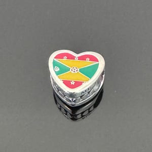 May include: Silver heart charm with a red, yellow, and green enamel design of the Jamaican flag.