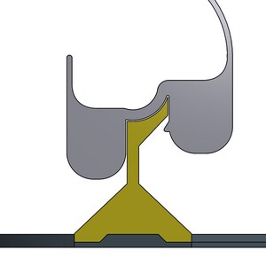 May include: A grey metal door stop with a curved top and a triangular base. The base is a dark yellow colour and sits on a black surface.