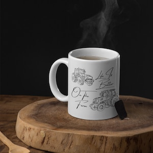 May include: White ceramic mug with a black outline of two tractors and the text "Life is Better On the Farm".