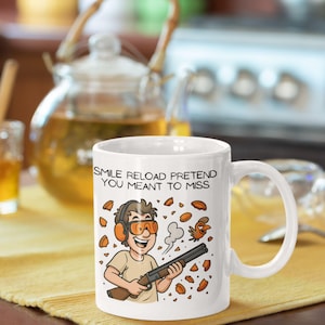 Smile Reload Pretend You Meant to Miss Mug – Funny Clay Shooting Cartoon – 11oz Ceramic Mug for Shooters