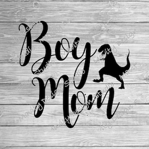 May include: Black and white graphic design with the text "Boy Mom" and a silhouette of a dinosaur.