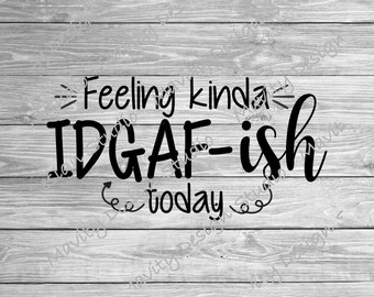 May include: Black and white graphic design on a wooden background. The text reads "Feeling kinda IDGAF-ish today" in a mix of fonts. The background is a light gray wood grain pattern.