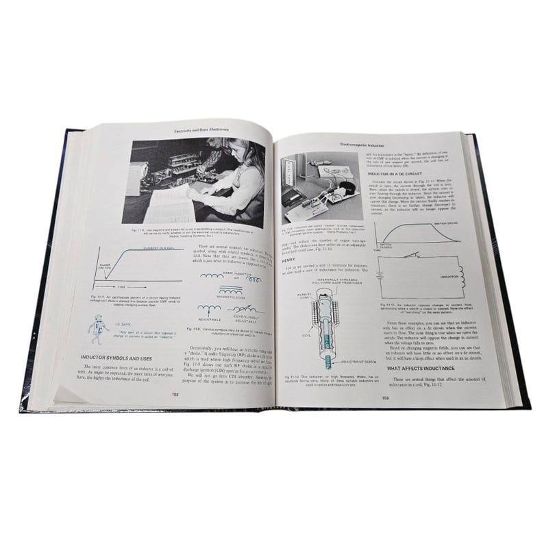 May include: An open book with black and white illustrations and text. The book is titled "Electricity and Basic Electronics." The pages show diagrams, schematics, and photographs related to electronics and electrical circuits.