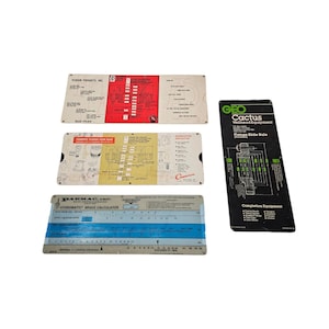 May include: A white ceramic mug with a black handle and the text "But First, Coffee" in a bold, black font. The mug is set against a blurred background, suggesting a cozy setting. The mug appears to be approximately 4 inches tall.