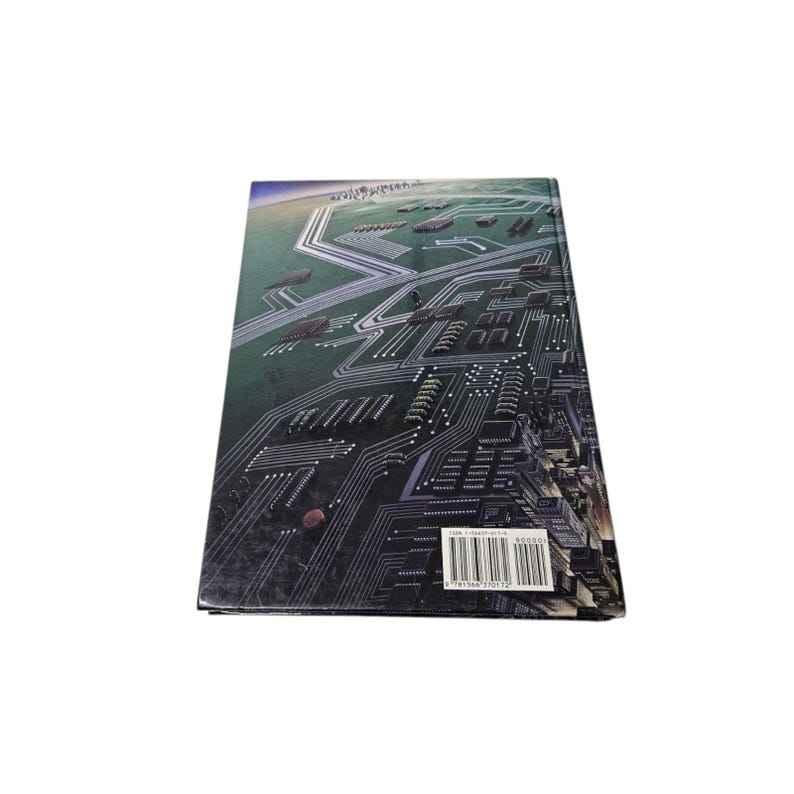 May include: A hardcover book with a cover featuring a detailed illustration of a circuit board design in shades of green, gray, and white. The book's spine is visible, and a barcode is present.
