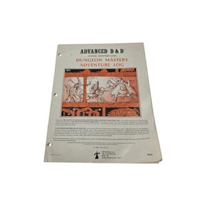 May include: A white Advanced D&D Dungeon Masters Adventure Log booklet with three-hole punches on the left side. The cover features a black and orange illustration of fantasy characters in combat, with the title printed in bold black and red text.
