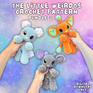 May include: Three plush crochet creatures from The Little Weirdos Crochet Pattern Bundle 2. One is light blue with white accents, one is orange with light green ears, and one is gray with purple ears. All have large dark eyes and soft textures.
