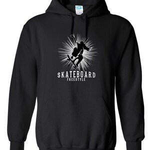 May include: Black hoodie with a white graphic of a skateboarder mid-trick, with a burst of lines behind. The text "SKATEBOARD FREESTYLE" is below the skater. The hoodie has a front pocket and a drawstring hood.