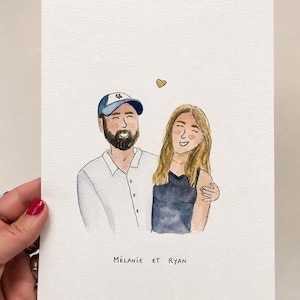 Peut inclure: Une illustration à l'aquarelle sur papier texturé représentant deux personnes souriantes. L'une porte une casquette de baseball bleue et blanche et une chemise blanche, l'autre a de longs cheveux blonds et un haut sombre. Un petit cœur doré et le texte Mélanie et Ryan.