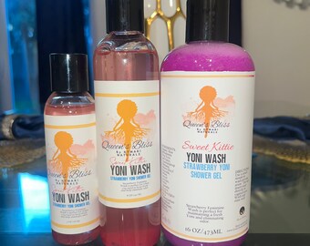 May include: Three bottles of strawberry-scented yoni wash, labeled "Queen's Bliss" and "Sweet Kittie". The bottles are pink, purple, and clear, and they are all labeled with the text "Yoni Wash" and "Strawberry Yoni Shower Gel".
