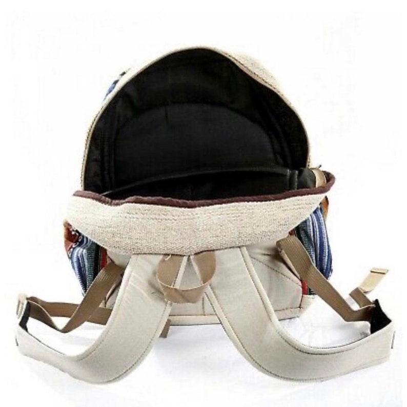 May include: A beige canvas backpack with blue and red striped fabric accents. The backpack has adjustable straps and a zippered closure.
