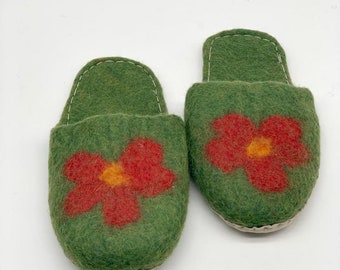 May include: A pair of green felt slippers with red flower embroidery.